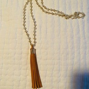 Pendant style necklace with brown leather tassel